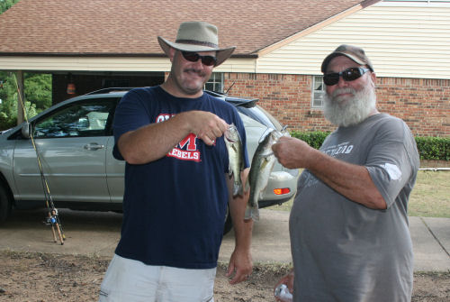 My nephew and husband comparing fish they caught