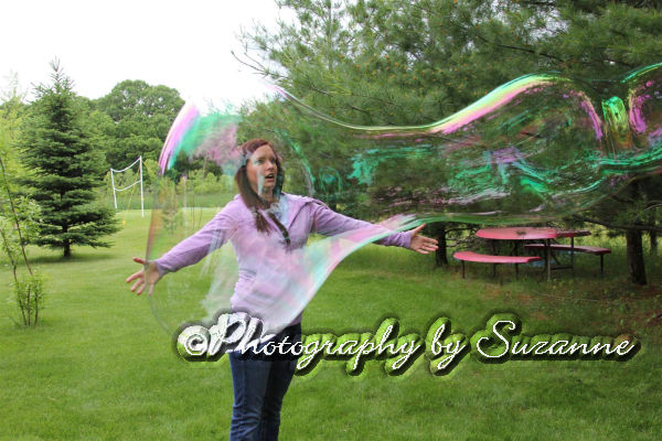 Woman blowing a giant bubble